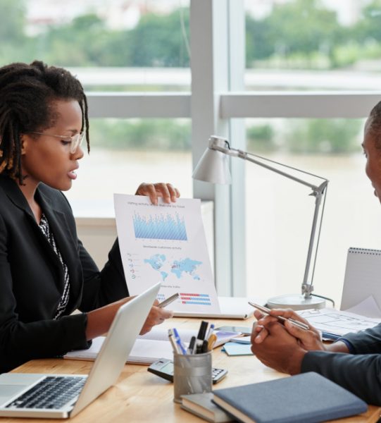 side-view-businesswoman-showing-analytical-charts-her-male-coworker